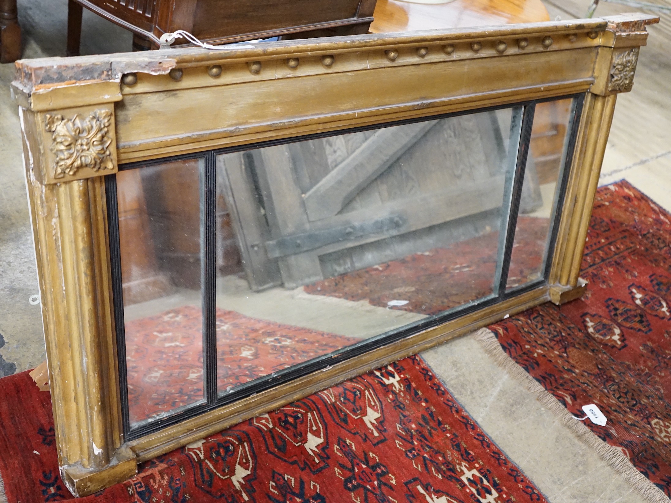 A Regency giltwood and gesso triple plate overmantel mirror (a.f.), width 137cm, height 69cm